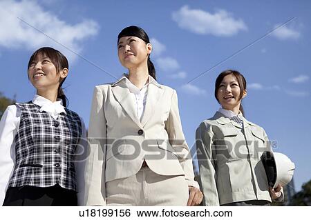 Businesswomen standing side by side looking away View Large Photo Image Stock Photograph - Businesswomen standing side by side looking away. Fotosearch