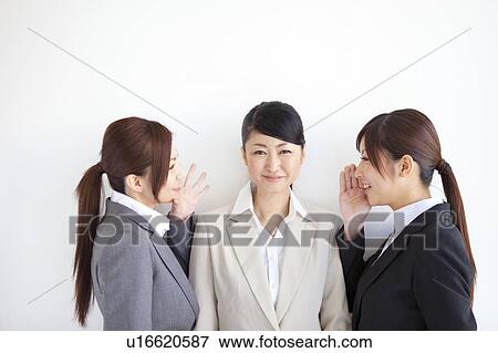 Businesswomen whispering View Large Photo Image Stock Photo - Businesswomen whispering. Fotosearch