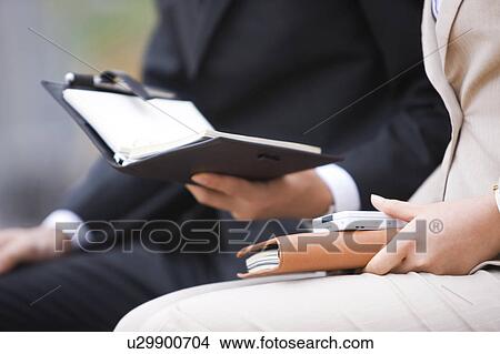 Picture - Close Up of Businesspeople with Diaries. Fotosearch