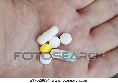 Picture - Close-up of pills on hand. Fotosearch