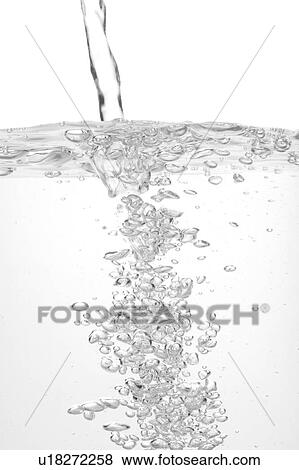 Stock Photo - Close-up of water being poured into glass. Fotosearch