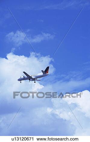 Stock Image - Commercial airplane flying, Japan. Fotosearch