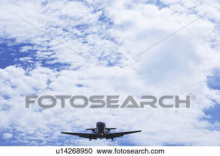 Stock Image - Commercial airplane flying, Japan. Fotosearch