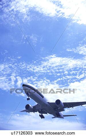 Stock Image - Commercial airplane flying, Japan. Fotosearch