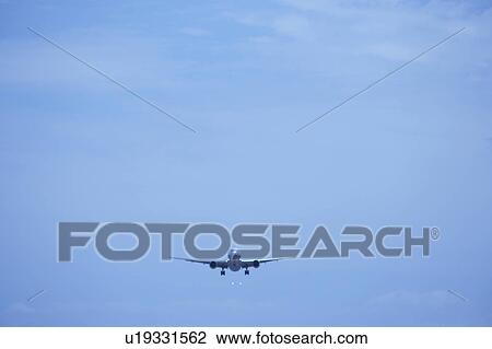 Stock Image - Commercial airplane flying, Japan. Fotosearch