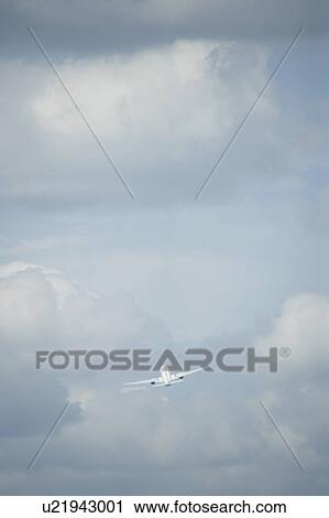Stock Image - Commercial airplane flying, Japan. Fotosearch