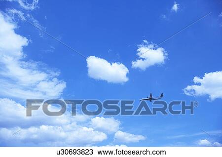 Stock Image - Commercial airplane flying, Japan. Fotosearch