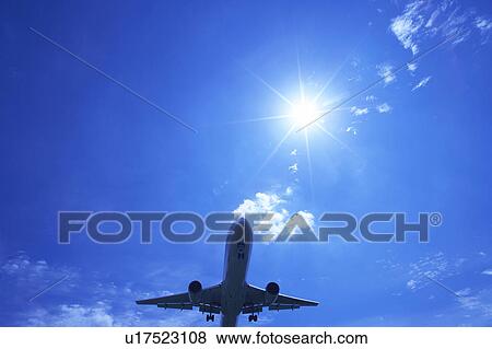 Stock Photo - Commercial airplane flying, Japan. Fotosearch