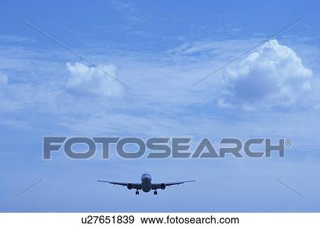 Stock Photo - Commercial airplane flying, Japan. Fotosearch