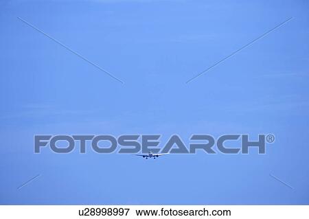 Stock Photo - Commercial airplane flying, Japan. Fotosearch