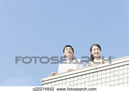 Stock Image - Couple at balcony, Hyogo Prefecture, Honshu, Japan. Fotosearch