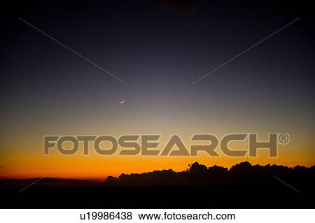 Stock Photo - Crescent Moon Over Landscape. Fotosearch