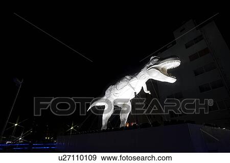 Stock Photo - Dinosaur Statue at Night. Fotosearch