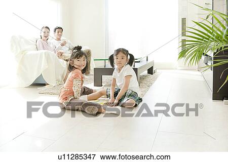 Family of Four in Living Room View Large Photo Image Stock Photo - Family of Four in Living Room. Fotosearch