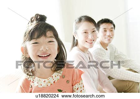 Family sitting on sofa View Large Photo Image Picture - Family sitting on sofa. Fotosearch