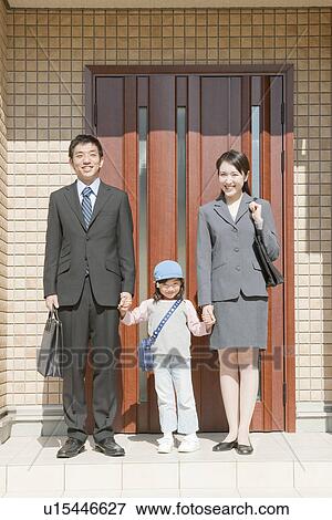 Stock Photo - Family standing in front of house, Hyogo Prefecture, Honshu, Japan. Fotosearch