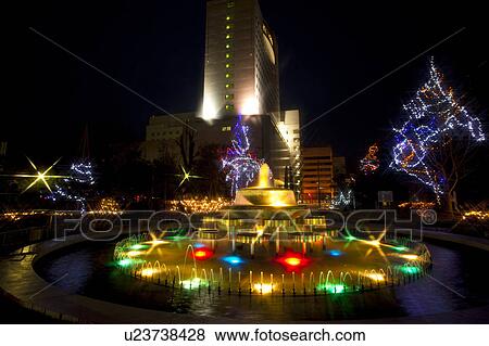 Stock Photo - Fountain and Park Decorated with Winter Lights. Fotosearch