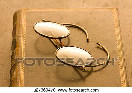 Stock Image - Glasses on book. Fotosearch