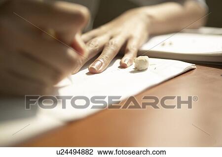 Stock Image - High school boy writing on note pad, Japan. Fotosearch