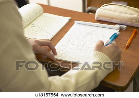 High school girl writing on note pad, Japan View Large Photo Image Picture - High school girl writing on note pad, Japan. Fotosearch