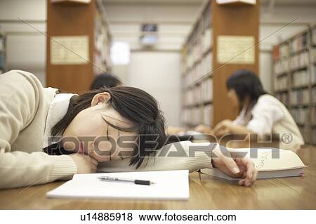 Stock Photo - High school student sleeping in library, Japan. Fotosearch