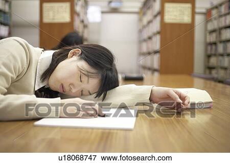Stock Photo - High school student sleeping in library, Japan. Fotosearch