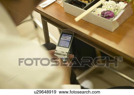 High school student text messaging during lunch time View Large Photo Image Stock Photo - High school student text messaging during lunch time. Fotosearch