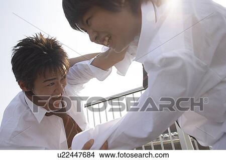 Picture - High school students fighting on rooftop, Japan. Fotosearch