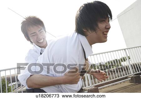 Stock Image - High school students on rooftop, Japan. Fotosearch