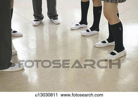 Stock Image - High school students talking in corridor, Japan. Fotosearch