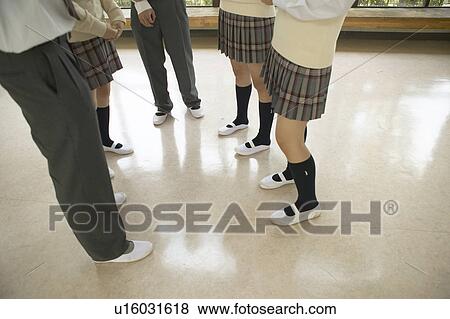 Stock Photo - High school students talking in corridor, Japan. Fotosearch