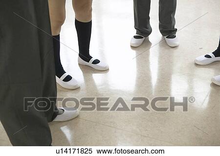 Stock Photography - High school students talking in corridor, Japan. Fotosearch