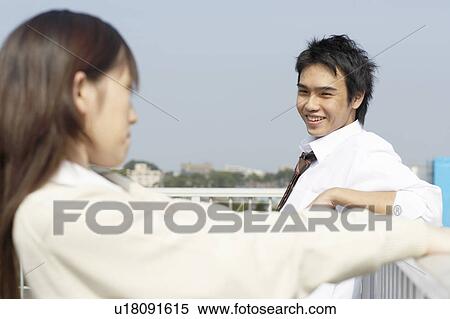 Stock Photography - High school students talking on rooftop, Japan. Fotosearch