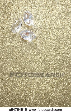 Stock Photograph - Jewelry on Golden Background. Fotosearch