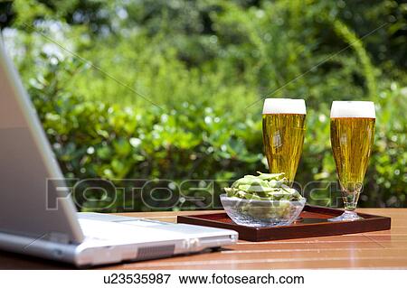 Laptop, beer and edamame View Large Photo Image Stock Photo - Laptop, beer and edamame. Fotosearch