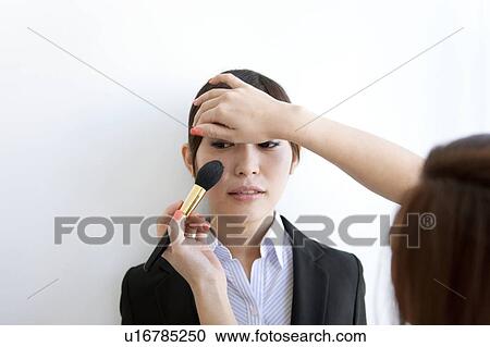 Make up artist putting make up on businesswoman View Large Photo Image Stock Image - Make up artist putting make up on businesswoman. Fotosearch