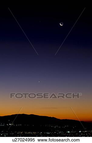 Stock Photography - Moon Over City at Dawn. Fotosearch