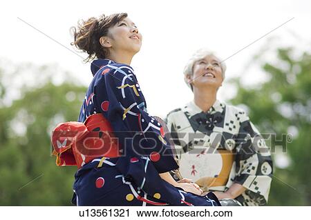 Mother and daughter wearing Yukata and sitting on bench View Large Photo Image Stock Image - Mother and daughter wearing Yukata and sitting on bench. Fotosearch