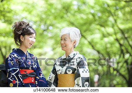 Stock Photo - Mother and daughter wearing Yukata and talking. Fotosearch