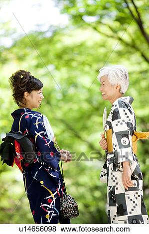 Stock Photo - Mother and daughter wearing Yukata and talking. Fotosearch