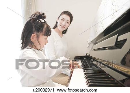 Mother Watching Daughter Playing Piano View Large Photo Image Stock Image - Mother Watching Daughter Playing Piano. Fotosearch