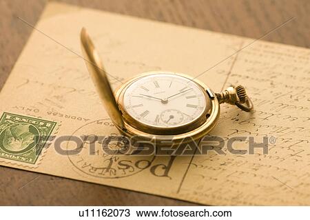 Stock Image - Pocket watch and postcard. Fotosearch