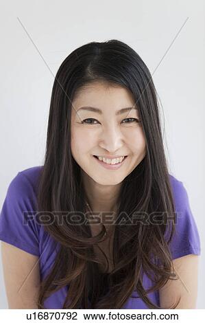 Stock Image - Portrait of a woman smiling. Fotosearch