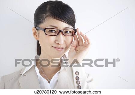 Stock Image - Portrait of businesswoman wearing glasses. Fotosearch