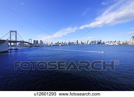 Stock Image - Rainbow Bridge and Tokyo Skyline. Fotosearch