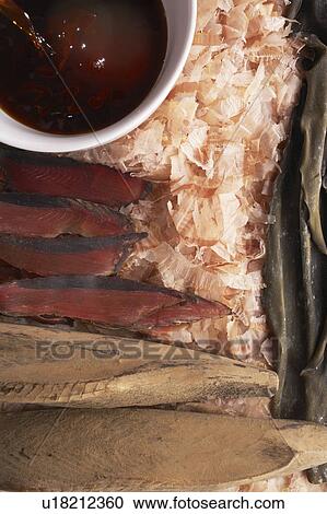 Stock Image - Sauce in a bowl, bonitos and seaweeds. Fotosearch