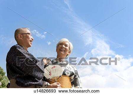 Stock Image - Senior couple wearing Yukata smiling. Fotosearch
