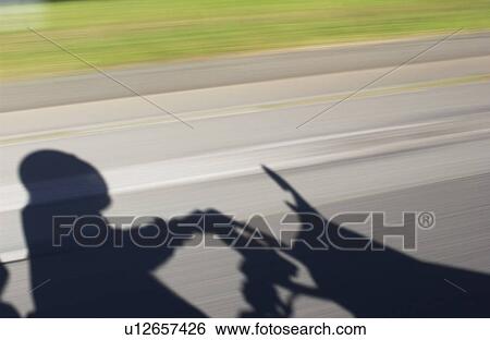 Shadow of adult driving a moped View Large Photo Image Stock Photograph - Shadow of adult driving a moped. Fotosearch