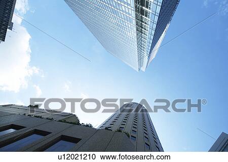Stock Image - Skyscrapers, low angle view, Osaka Prefecture, Honshu, Japan. Fotosearch