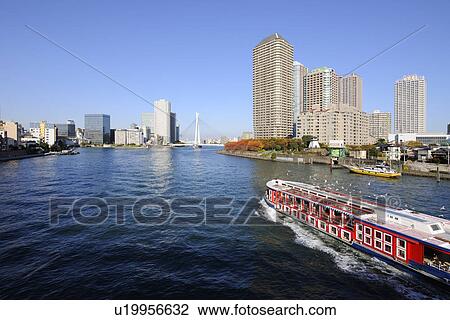 Stock Image - Sumida River and Boat Seen From Kachidoki Bridge. Fotosearch